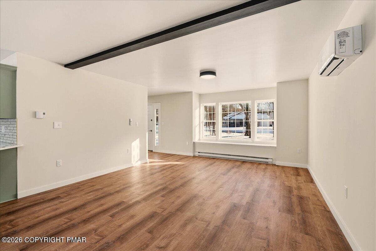 167 Bull Run Long Pond, PA 18334 - Photo 7 of 35 a view of an empty room with wooden floor and a window