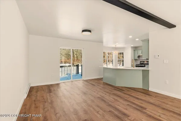 a view of kitchen and wooden floor