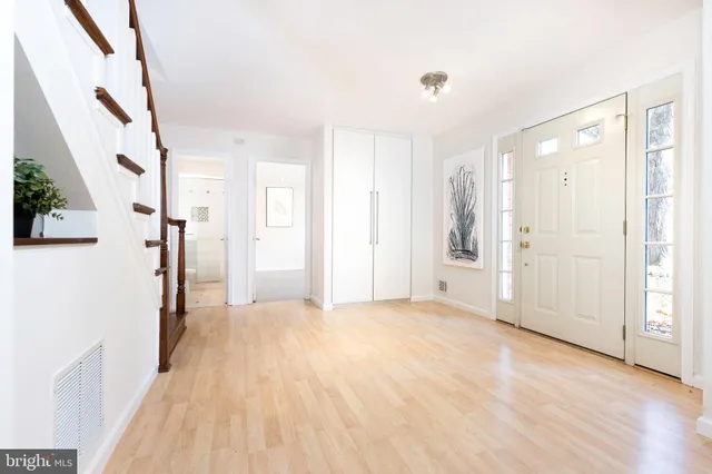 a view of a big room with wooden floor and windows