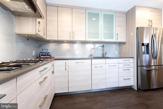 a kitchen with white cabinets and white appliances