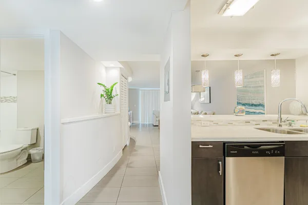 a bathroom with a granite countertop sink a toilet and a mirror