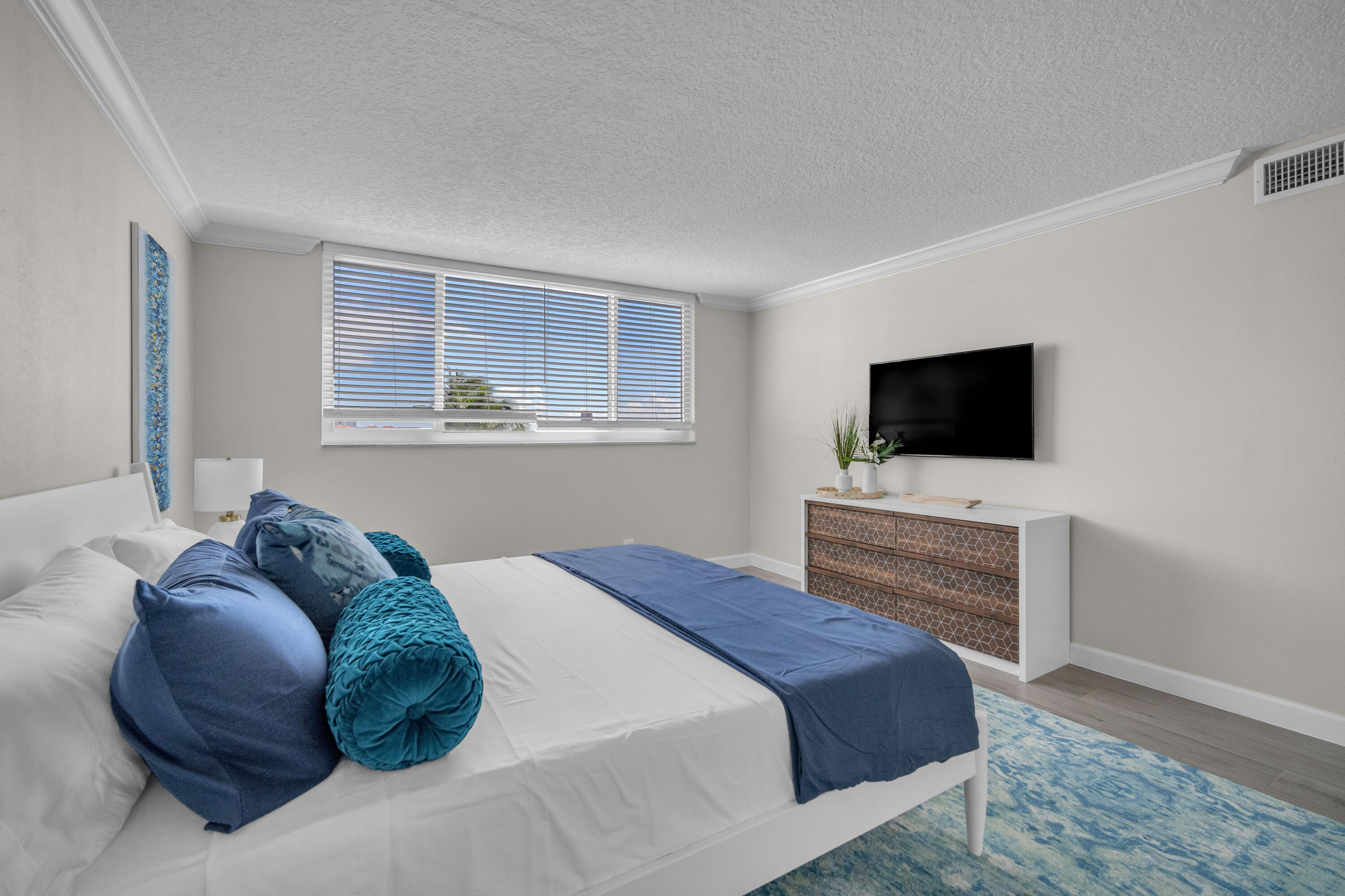 601 North Ocean Boulevard, Unit 503 Boca Raton, FL 33432 - Photo 5 of 7 a bedroom with a bed tv on table and a window