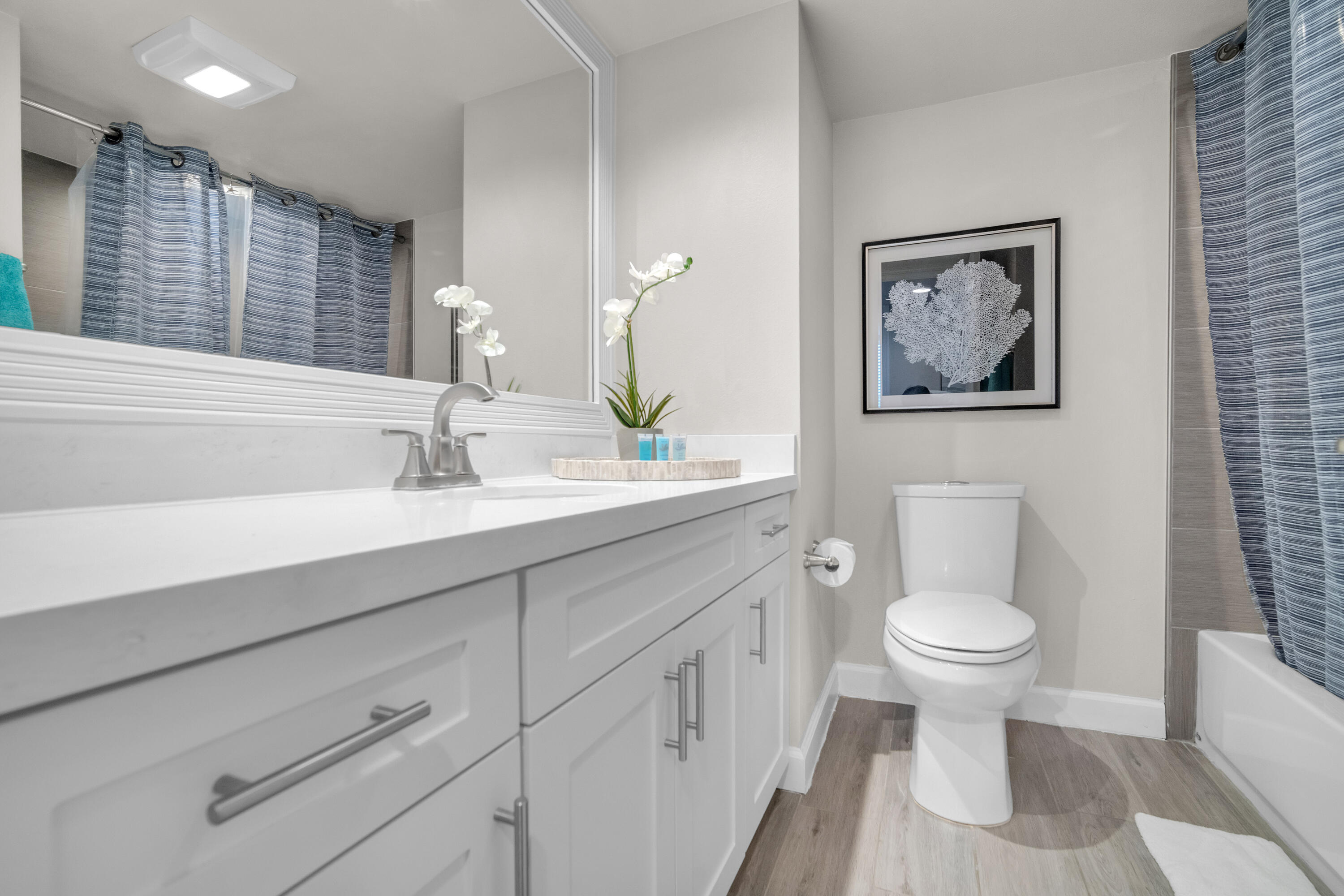 601 North Ocean Boulevard, Unit 503 Boca Raton, FL 33432 - Photo 7 of 7 a bathroom with a toilet sink and mirror