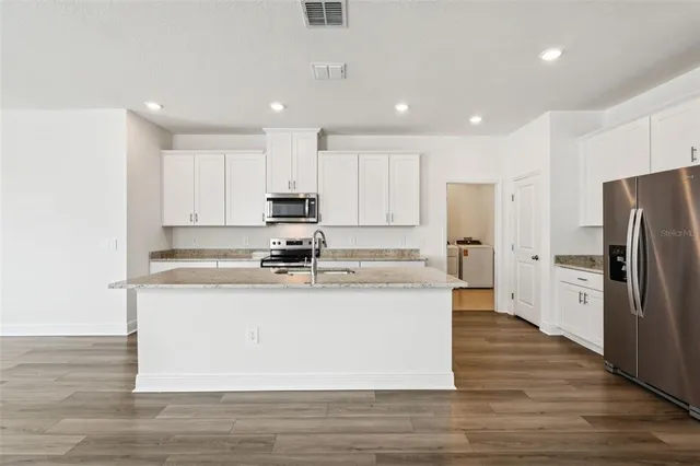 a large kitchen with stainless steel appliances