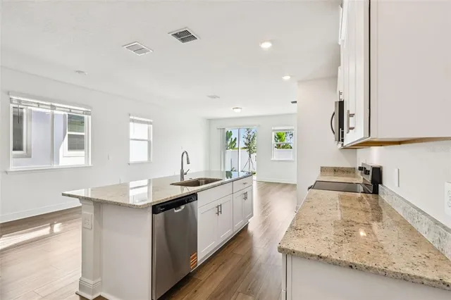 a kitchen with sink stove and cabinets