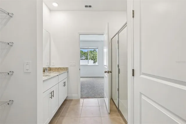 a bathroom with a granite countertop sink a toilet and shower