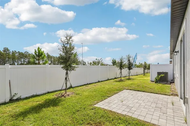 a backyard of a house with table and chairs