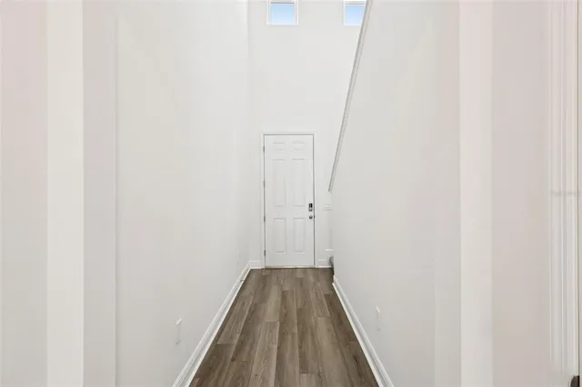 a view of a hallway with wooden floor