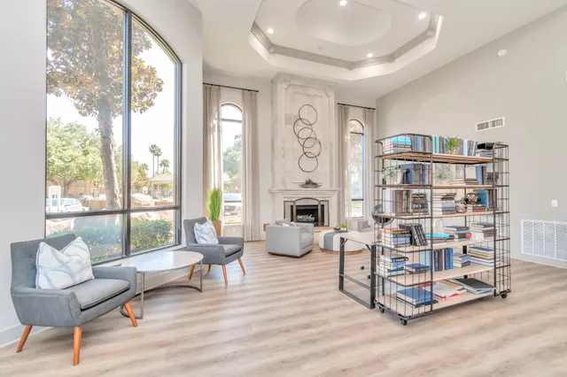 a living room with furniture and a floor to ceiling window
