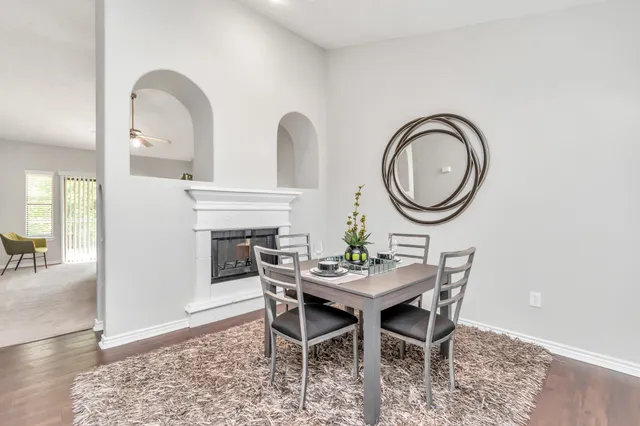 a dining room with furniture and a mirror
