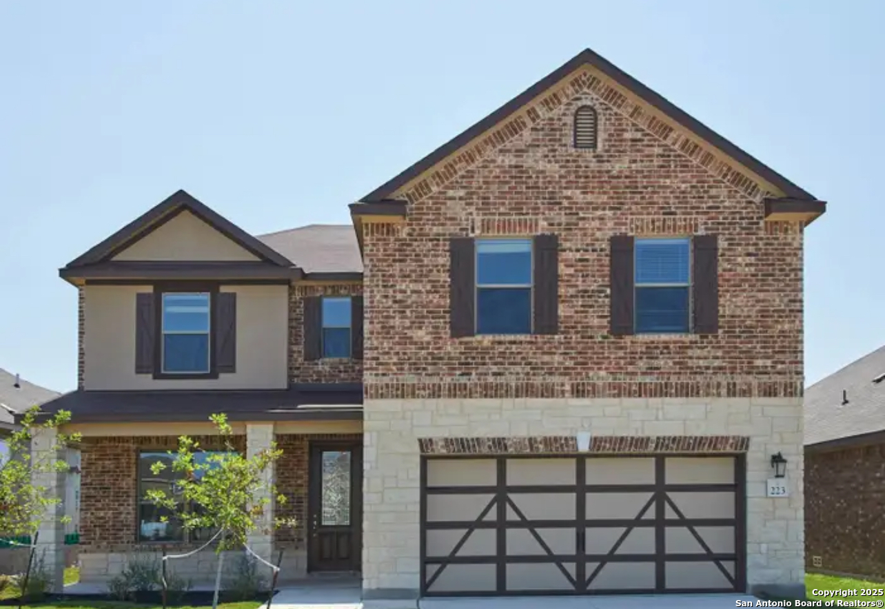 a front view of a house with plants