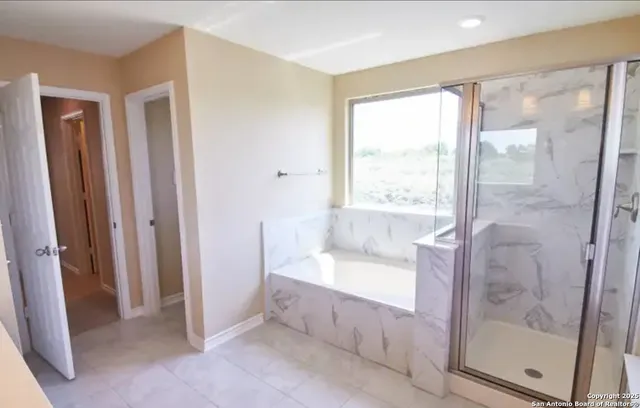 a bathroom with a bathtub and a shower