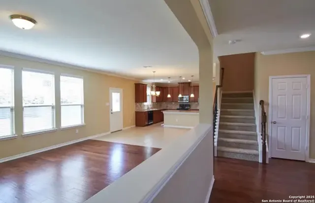 a view of kitchen and hall with wooden floor