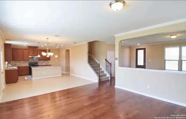 a view of a living room with kitchen furniture and a kitchen view