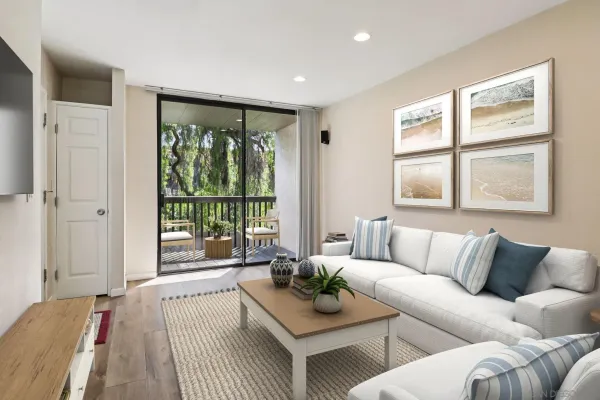 a living room with furniture a flat screen tv and a window