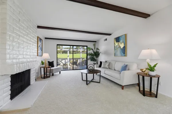 a living room with furniture and a potted plant