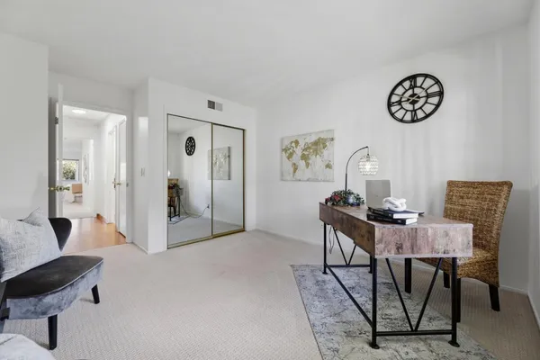 a spacious bedroom with a bed and a couch