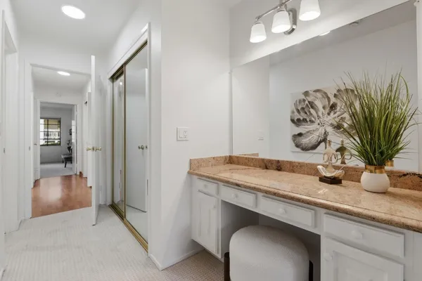 a bathroom with a granite countertop sink mirror and toilet