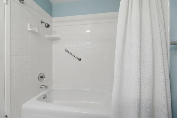 a bathroom with a granite countertop sink a toilet and mirror