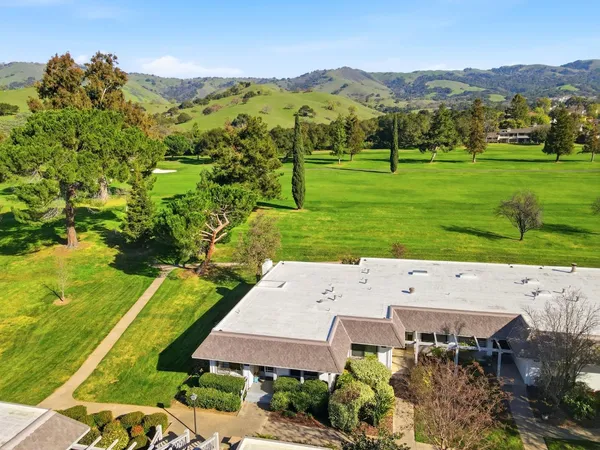 an aerial view of a houses with a yard