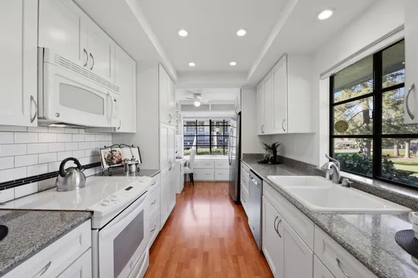 a kitchen with sink and cabinets