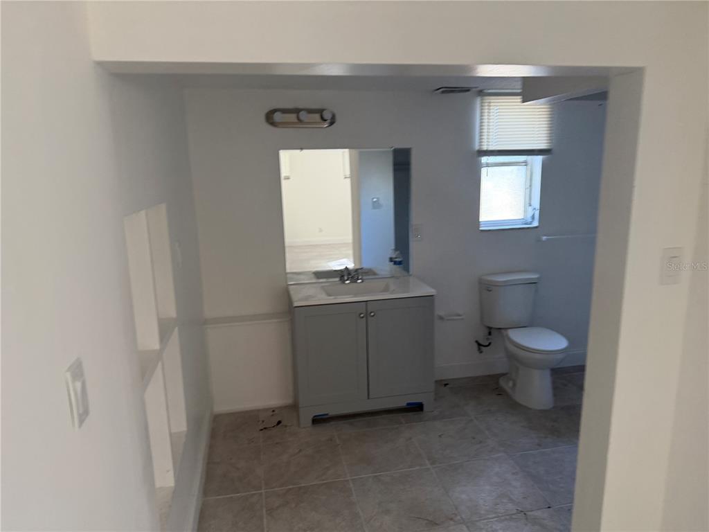2713 Adams Street West Inverness, FL 34453 - Photo 6 of 11 a bathroom with a toilet a sink and mirror