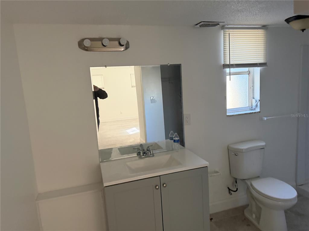 2713 Adams Street West Inverness, FL 34453 - Photo 8 of 11 a bathroom with a toilet sink and mirror