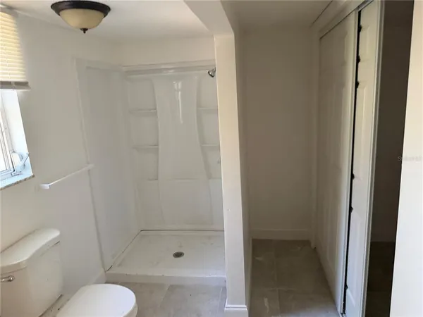 a bathroom with a shower a toilet and a sink