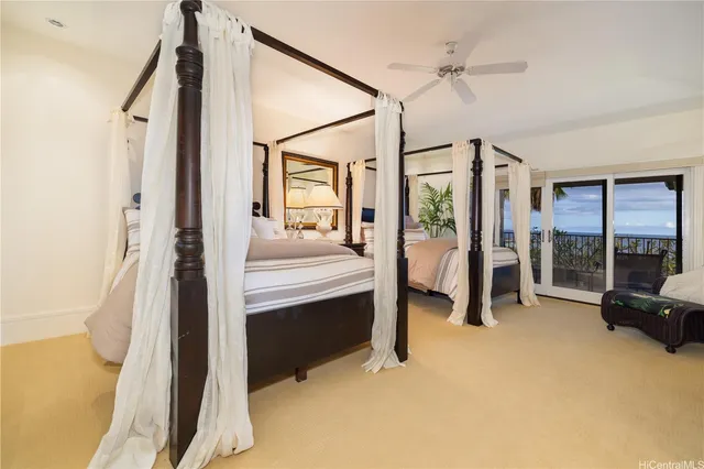 a bedroom with a bed and a couch next to a window