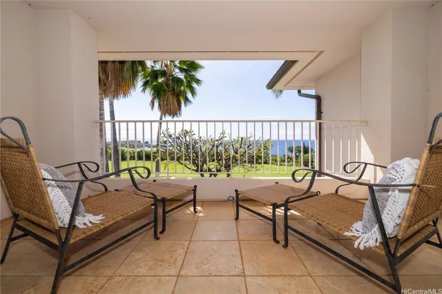 a living room with a couch and a potted plant