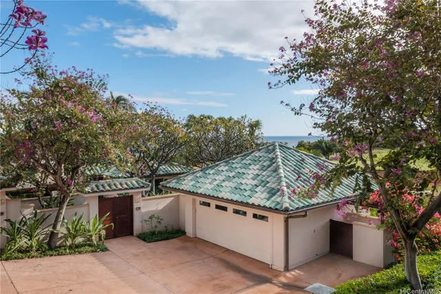 a aerial view of a house with a yard and lake view