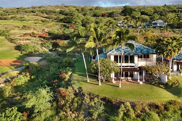 an aerial view of residential houses with outdoor space and trees