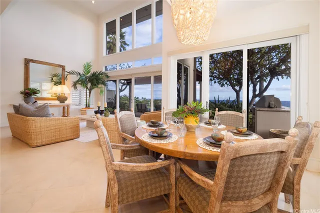 a dining room with furniture a rug and a large window