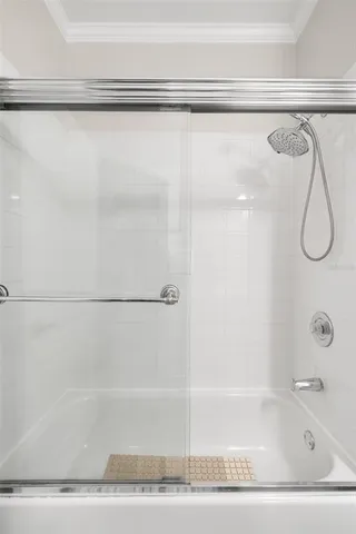 a bathroom with a shower and a bath tub