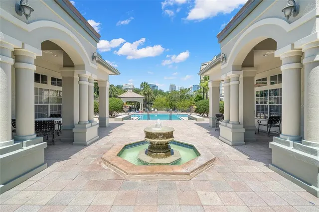 a swimming pool with outdoor seating