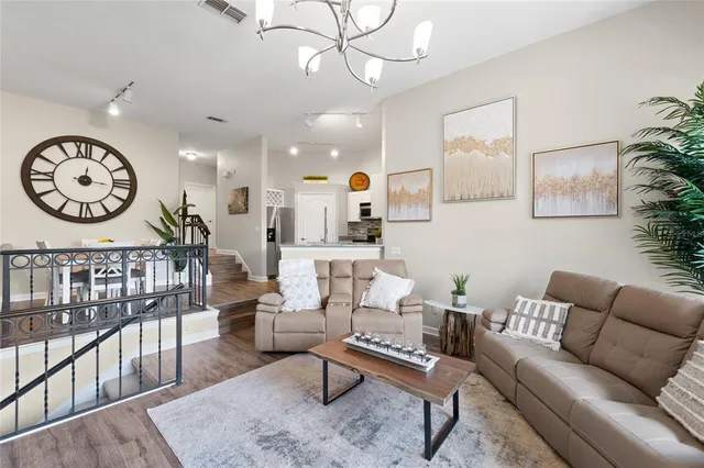 a living room with furniture a rug and a large window