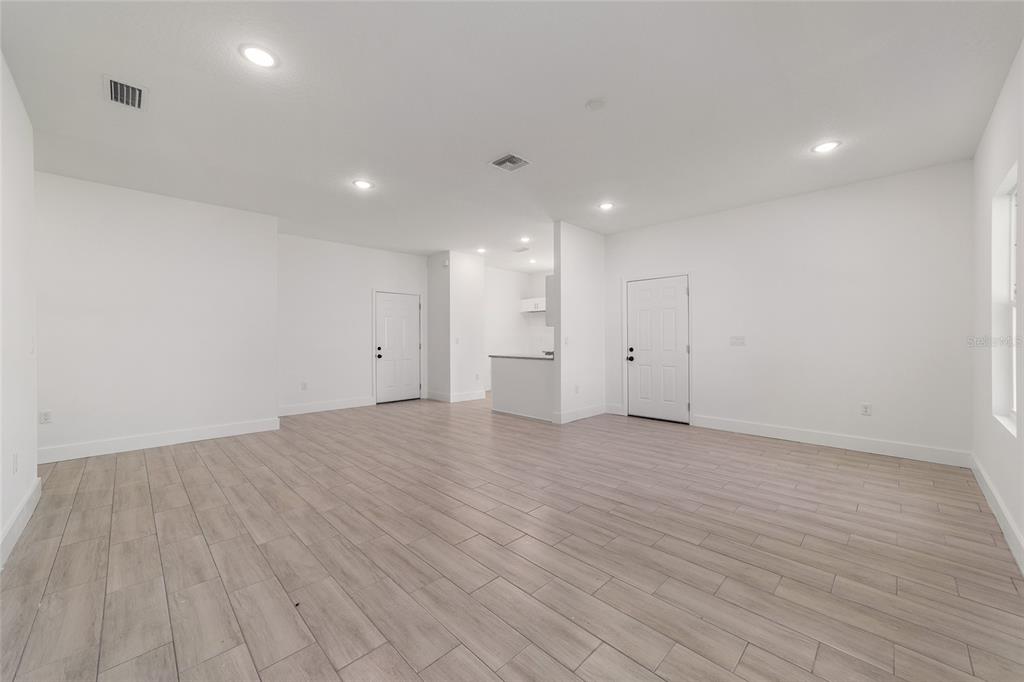 15431 Southwest 41st Street Road Ocala, FL 34481 - Photo 36 of 44 a view of an empty room with wooden floor