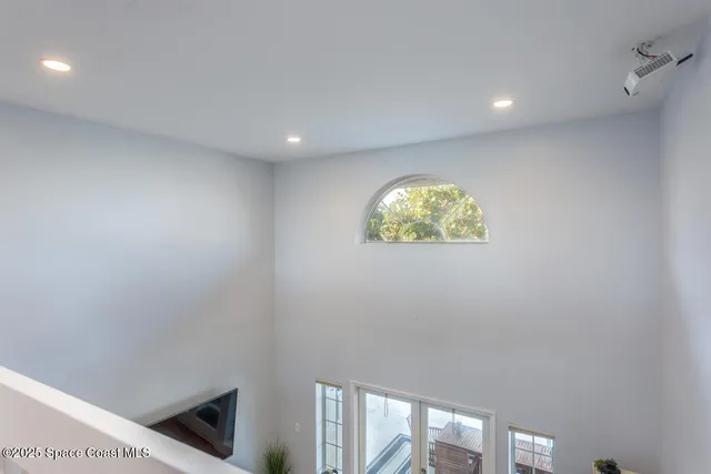 a living room with furniture and a floor to ceiling window