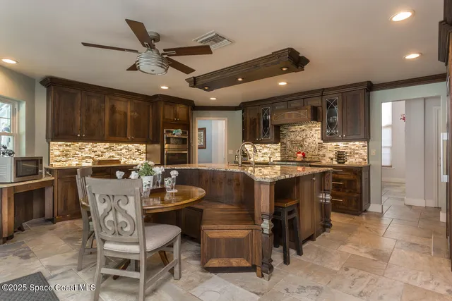 a kitchen with stainless steel appliances granite countertop a sink and refrigerator