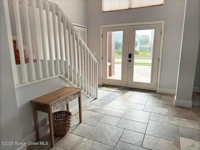 an empty room with windows and entryway