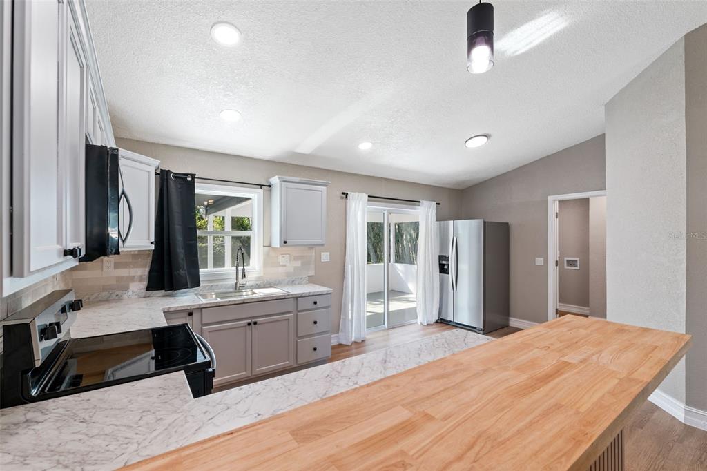 606 Kings Lane Southwest Winter Haven, FL 33880 - Photo 12 of 50 a room with a bed and a large window