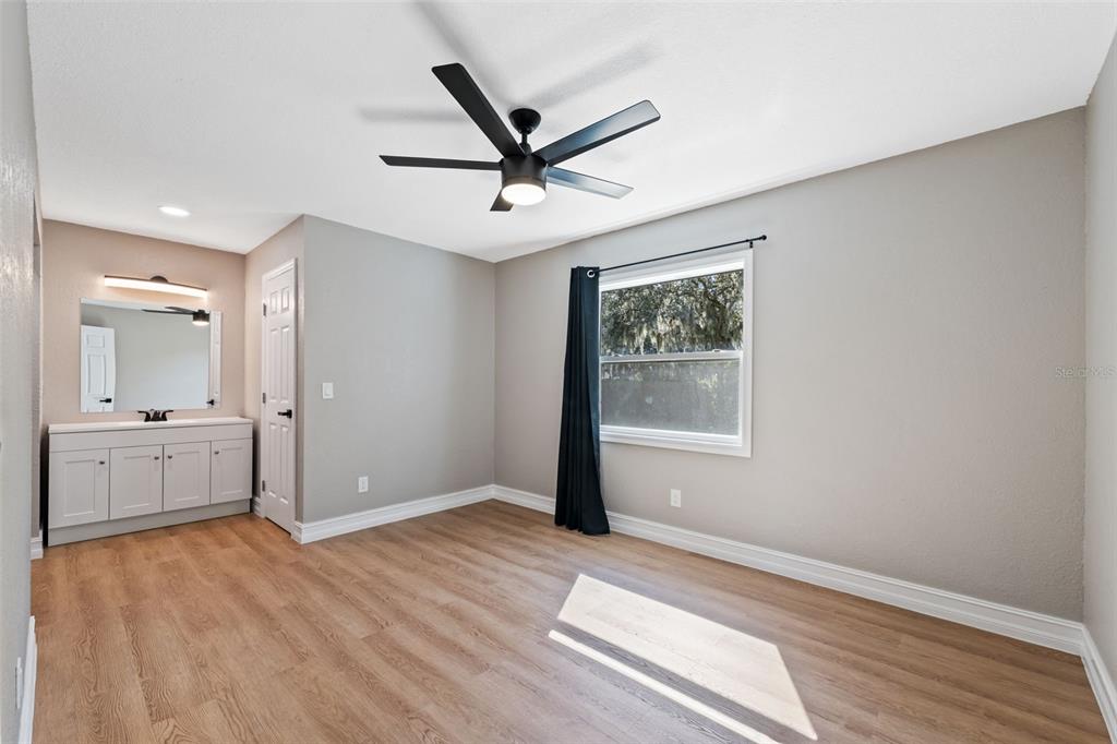 606 Kings Lane Southwest Winter Haven, FL 33880 - Photo 14 of 50 a view of livingroom with hardwood floor and a ceiling fan