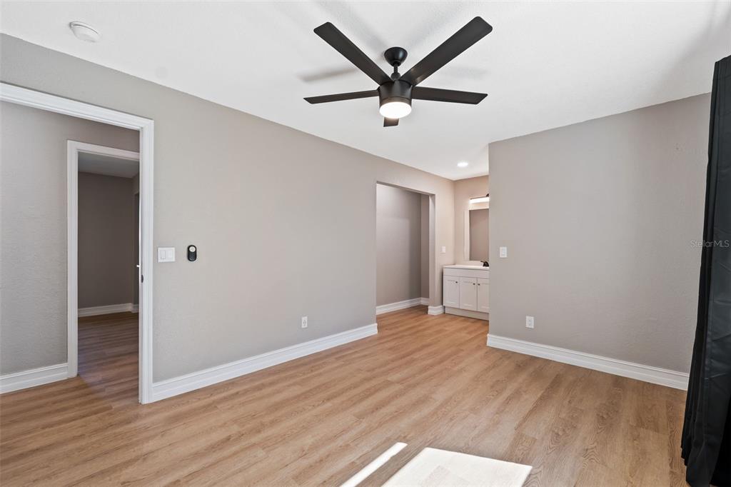 606 Kings Lane Southwest Winter Haven, FL 33880 - Photo 15 of 50 an empty room with wooden floor and windows