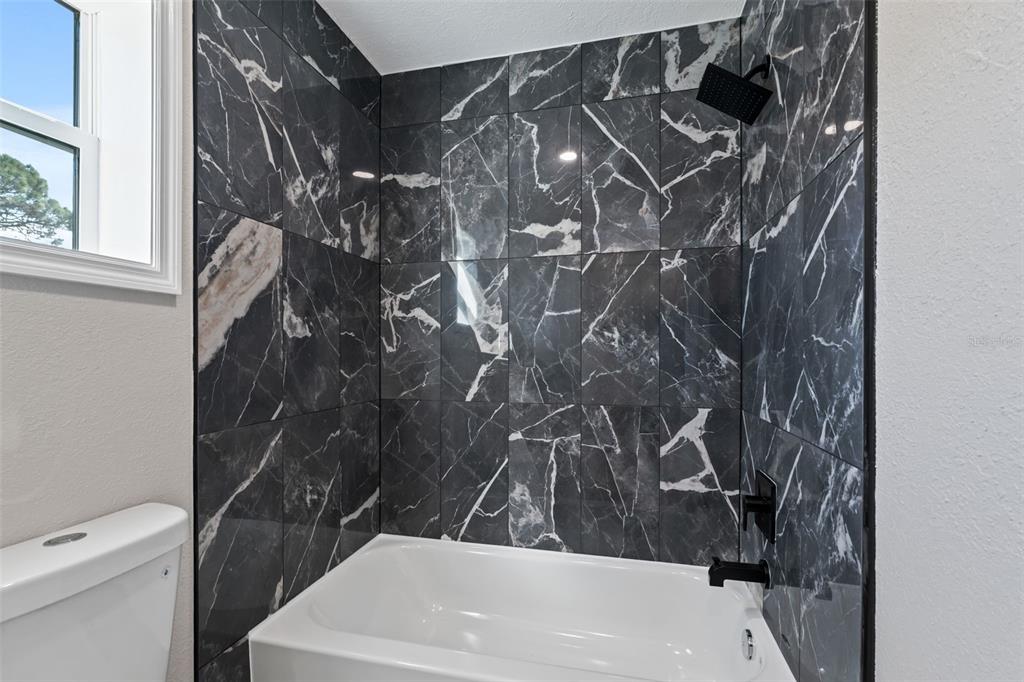 606 Kings Lane Southwest Winter Haven, FL 33880 - Photo 18 of 50 a bathroom with a sink and toilet