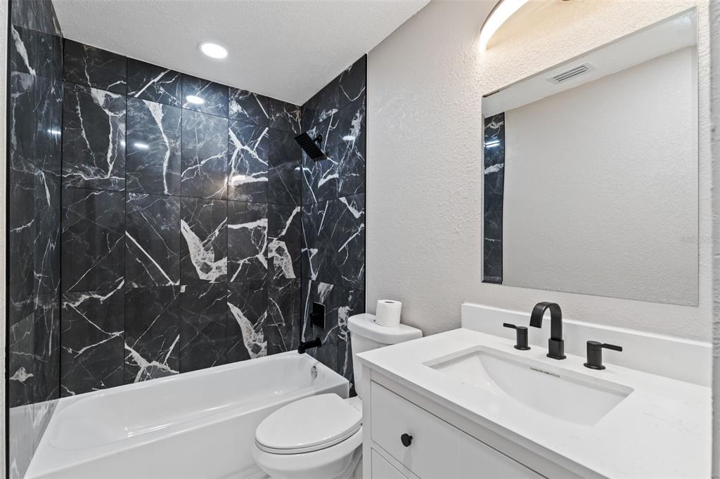 606 Kings Lane Southwest Winter Haven, FL 33880 - Photo 21 of 50 a bathroom with a sink toilet and shower