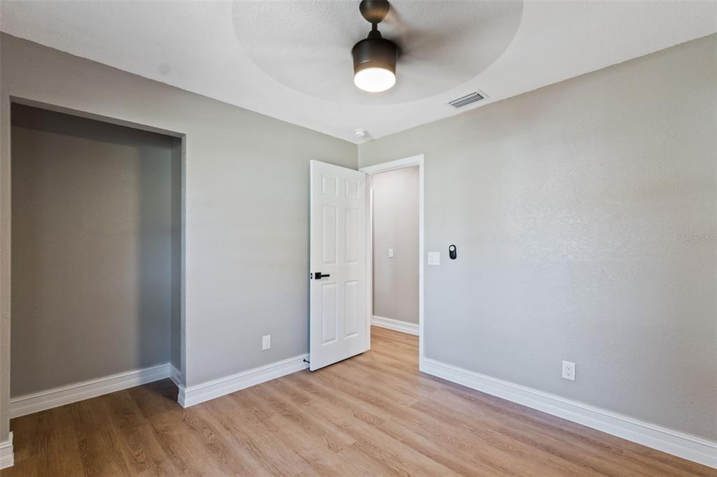 606 Kings Lane Southwest Winter Haven, FL 33880 - Photo 23 of 50 a view of an empty room with wooden floor