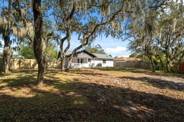 a view of a house with yard and sitting area