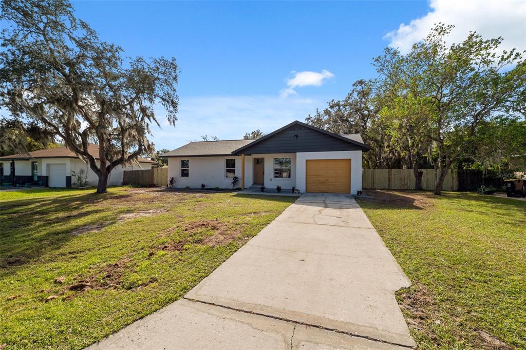 606 Kings Lane Southwest Winter Haven, FL 33880 - Photo 33 of 50 a front view of a house with a yard