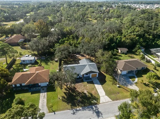 an aerial view of house with yard swimming pool and outdoor seating