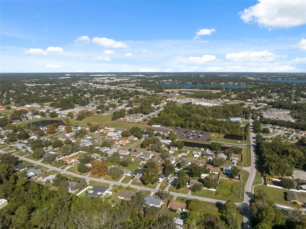 606 Kings Lane Southwest Winter Haven, FL 33880 - Photo 47 of 50 an aerial view of residential building with green space